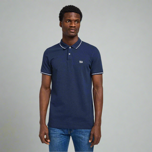 A man wears a navy polo shirt