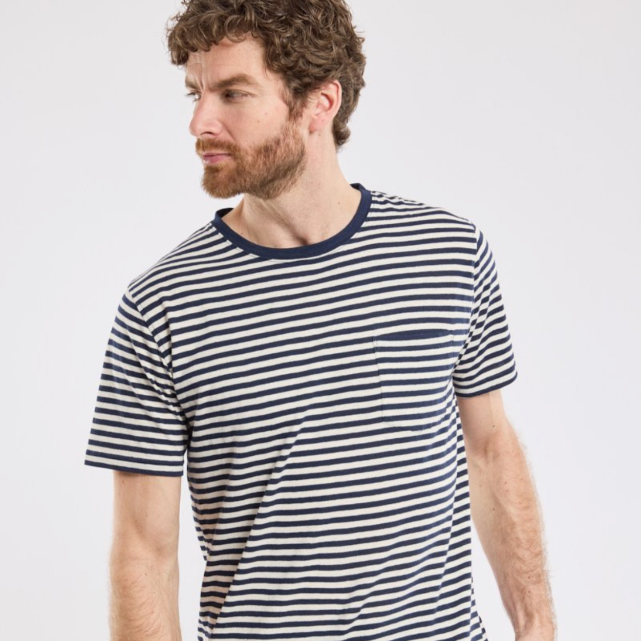 A man wears a striped t-shirt