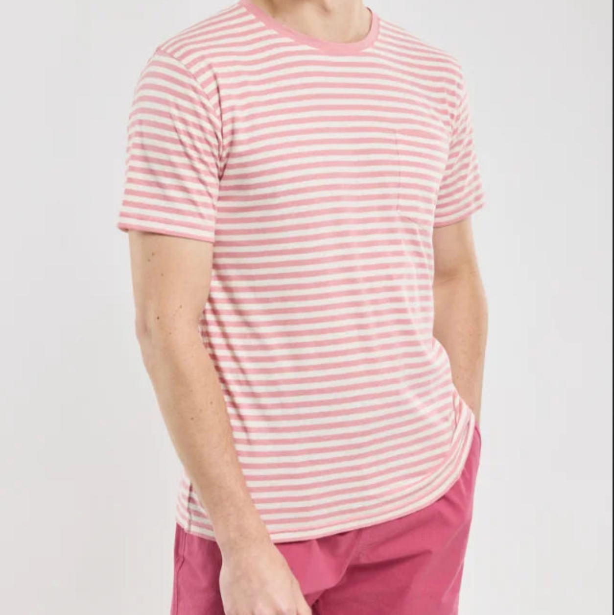 A man wears a pink t-shirt