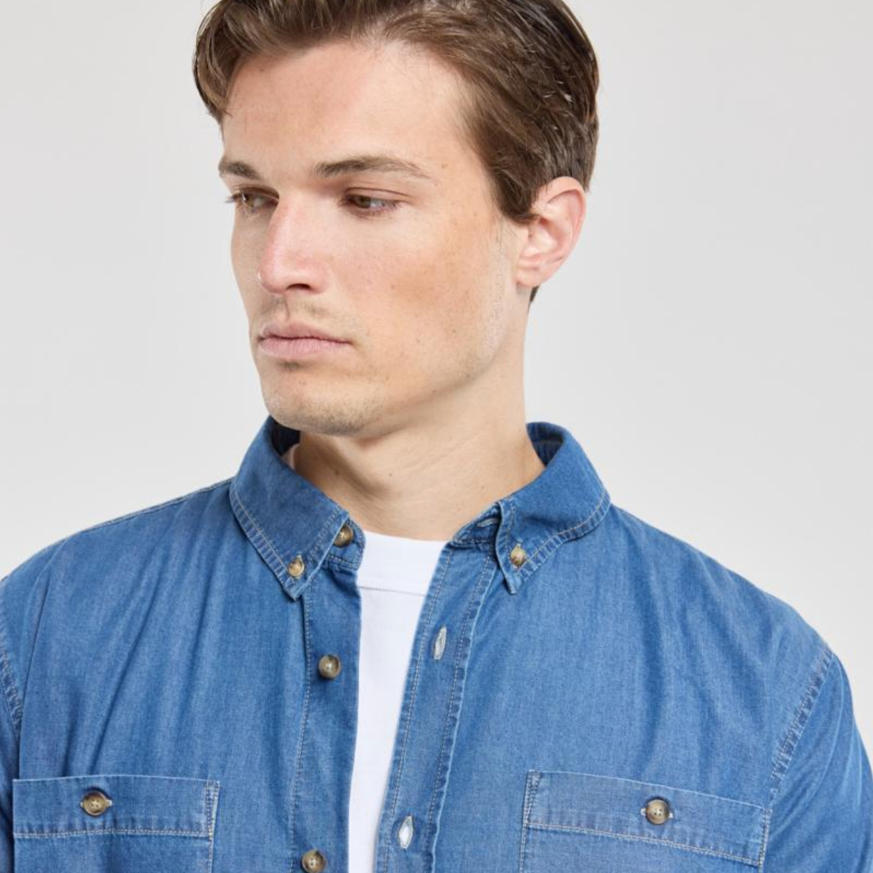 A man wearing a denim overshirt