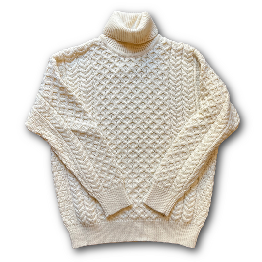 Cream-colored wool knitted Aran Craft sweaterwith a high neck sold at regent in salisbury