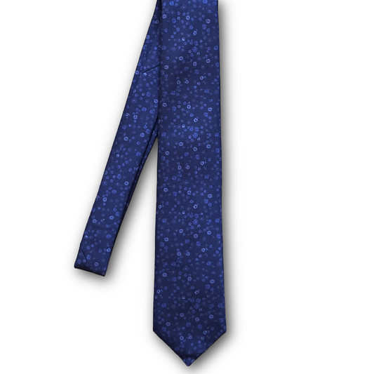 A blue necktie with a small, dense pattern of light blue and white flowers, shown against a plain white background.