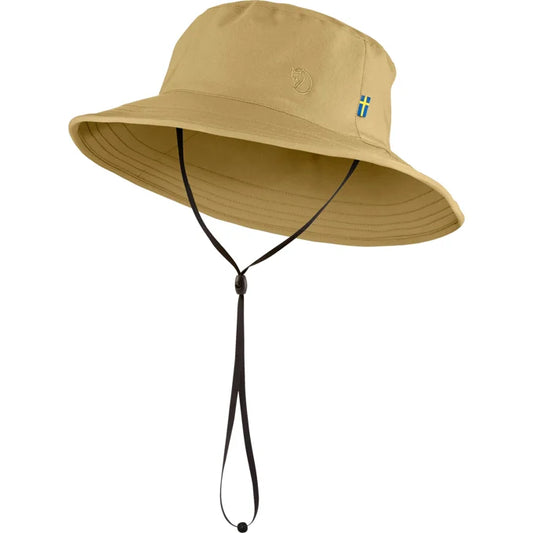 Beige Hat with wide brim and wind cord.