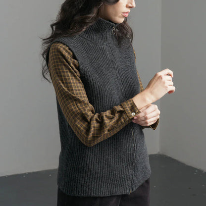 Person wearing a dark gray knitted vest , 100% wool. Available Regent Tailoring Salisbury UK