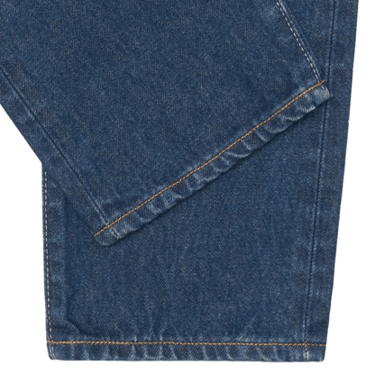 Close up of the dark denim legs including a orange/yellow hem