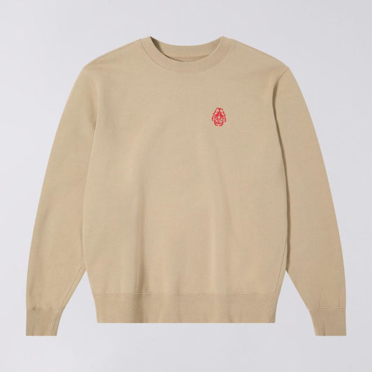 Beige sweater with a red logo on a light gray background