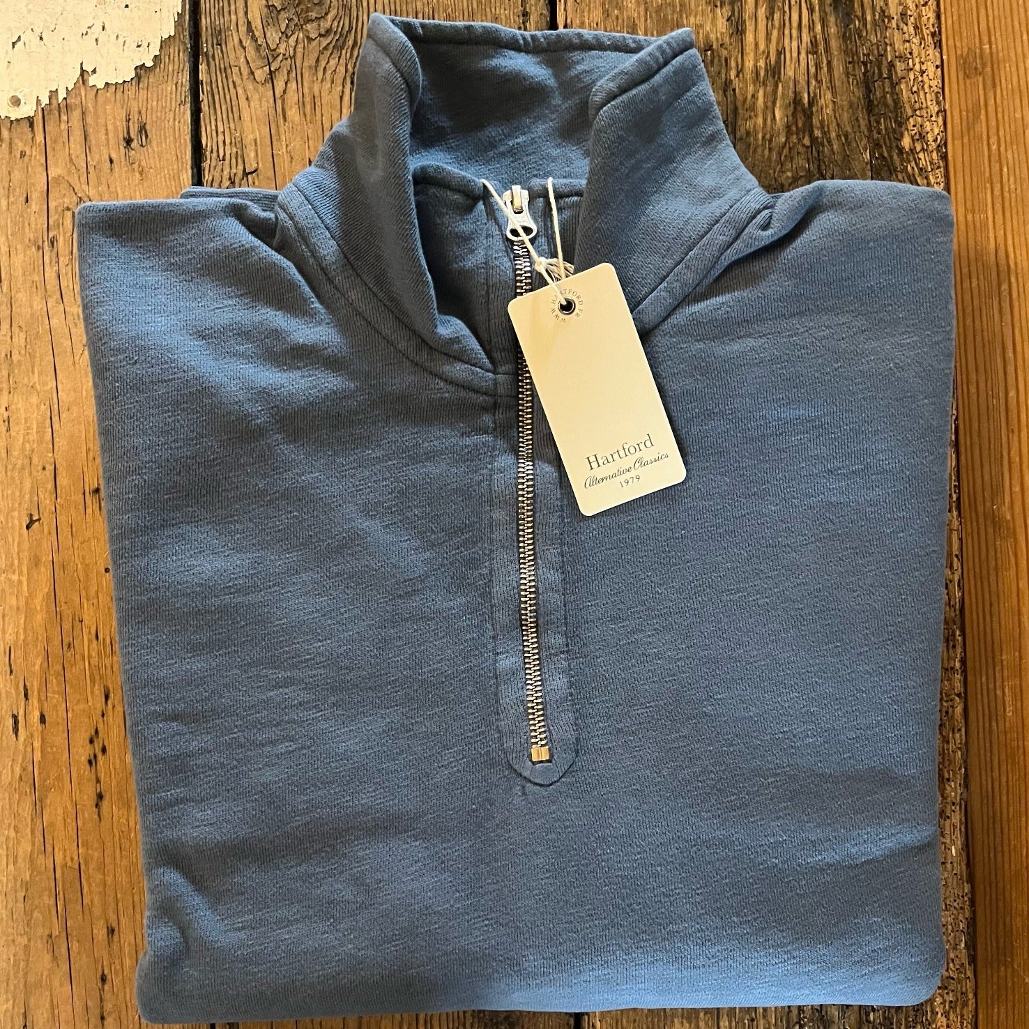 Blue half zip sweatshirt with collar and kangaroo pouch.