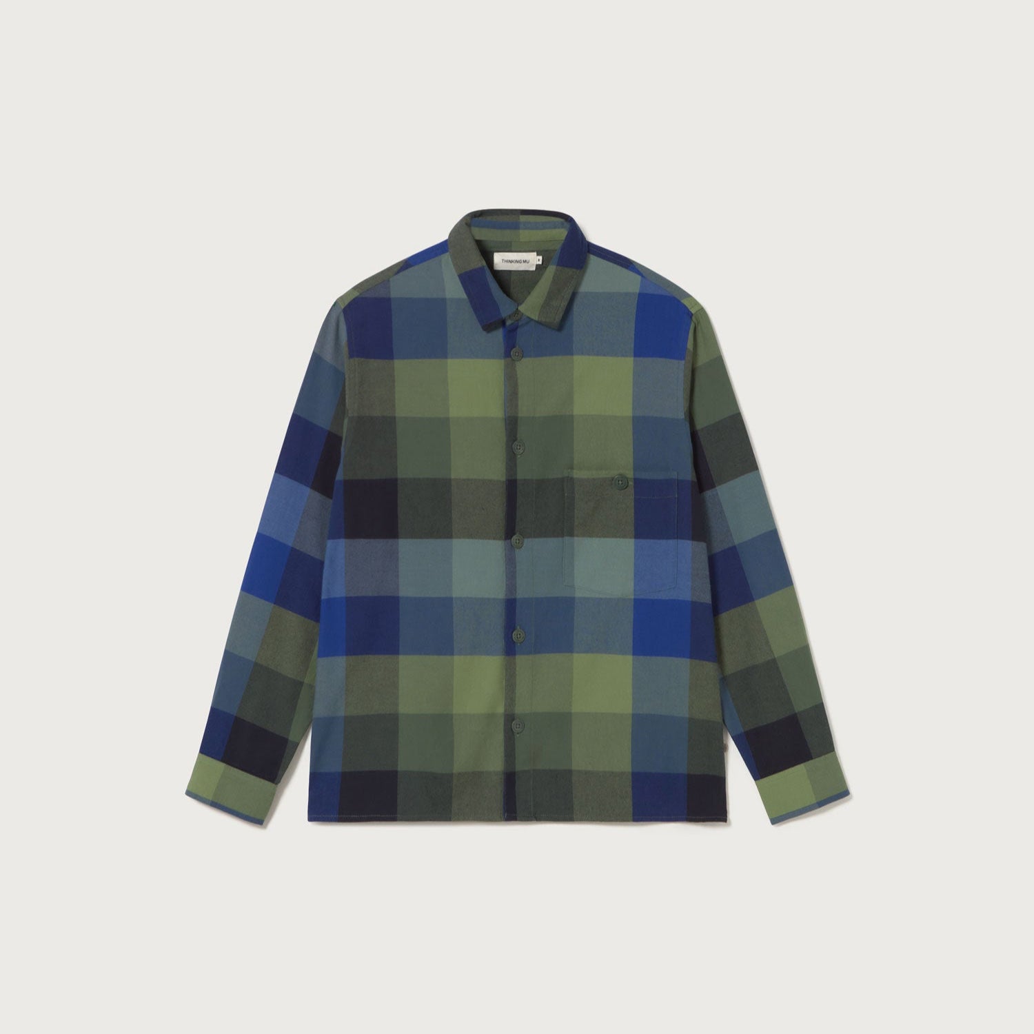 Plaid shirt with green and blue pattern on a light gray background