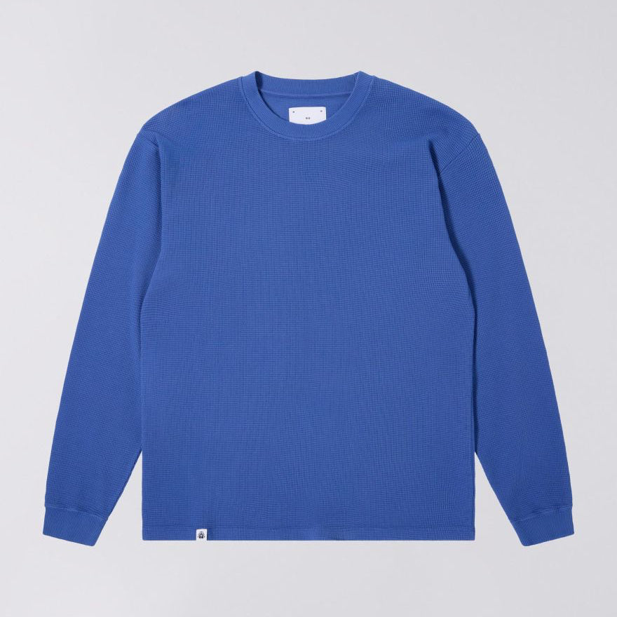Blue long-sleeve shirt on a light gray background