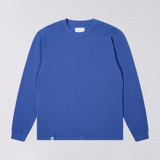 Blue long-sleeve shirt on a light gray background