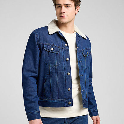Man wearing a blue denim jacket with white collar on a gray background