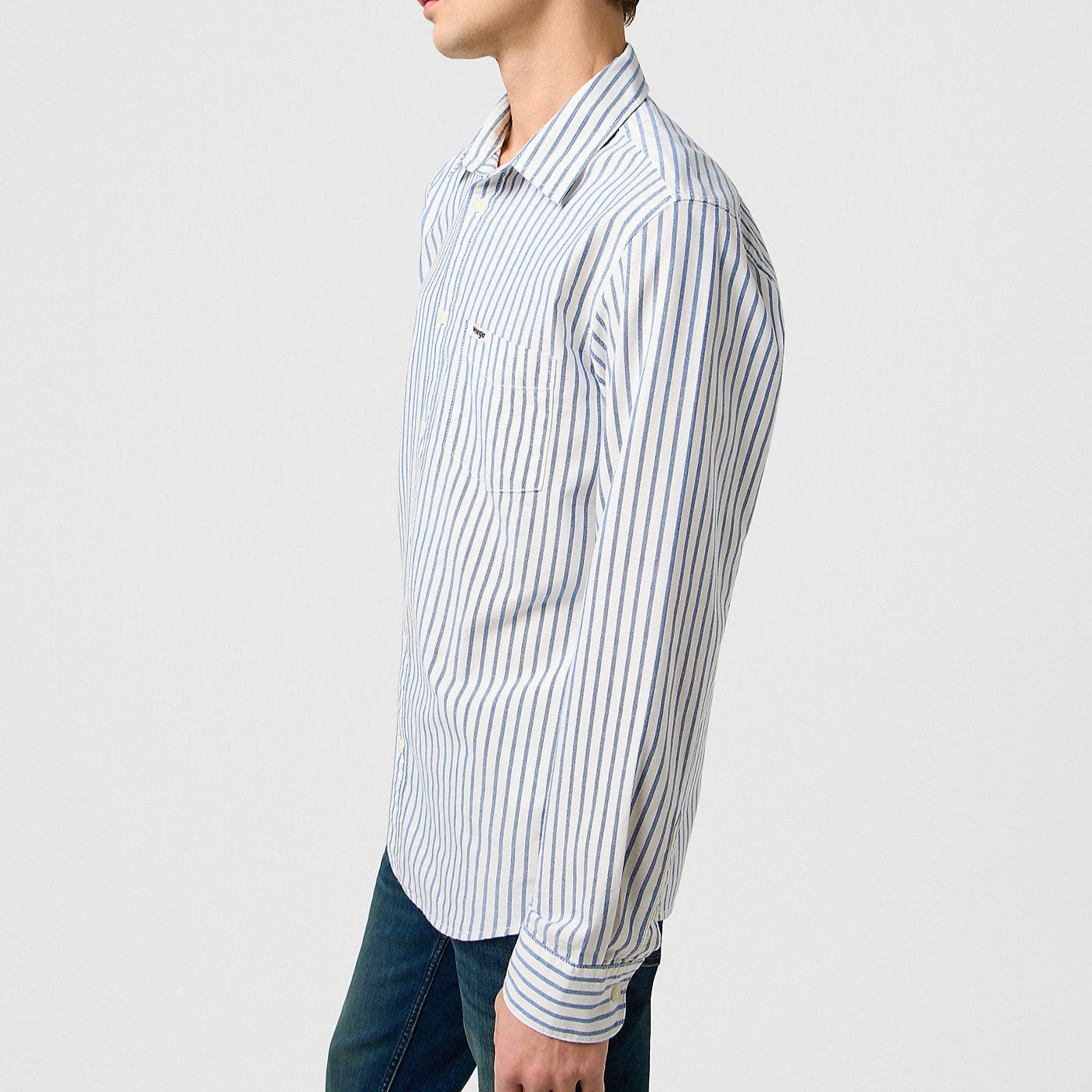 Man wearing a striped shirt against a plain background