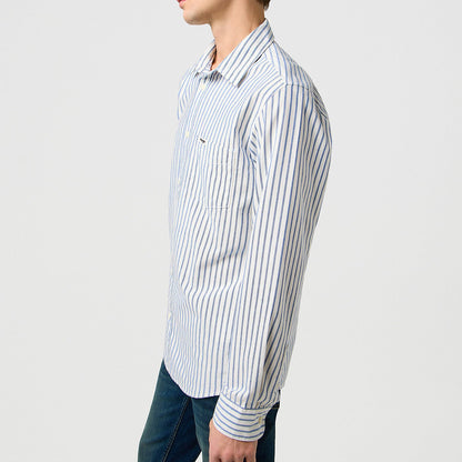 Man wearing a striped shirt against a plain background