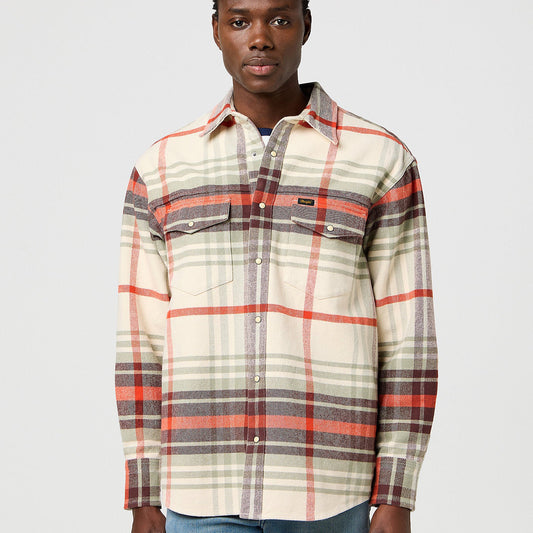 Man wearing a plaid shirt with red and gray patterns on a light gray background