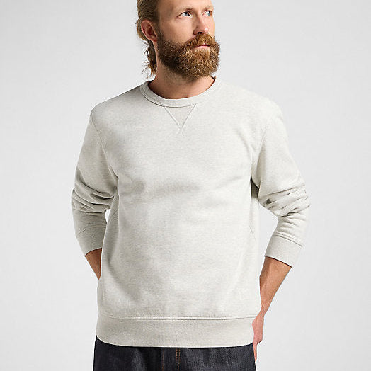 Man wearing a light gray sweatshirt against a plain background