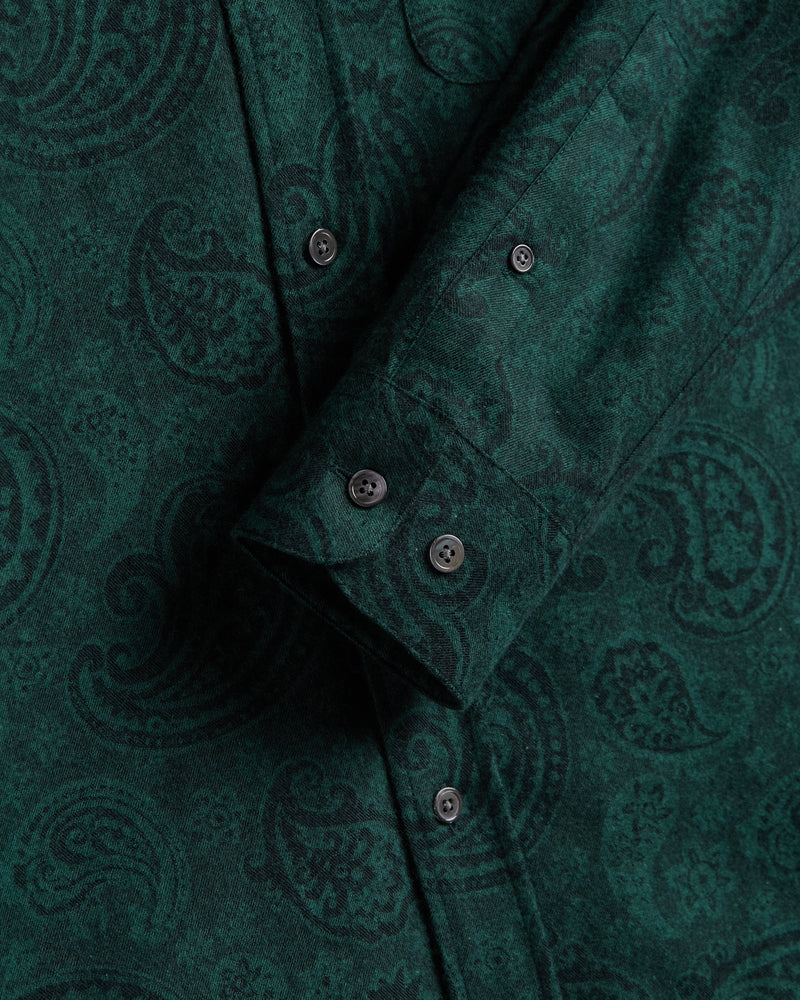 Close-up of a green patterned shirt with buttons