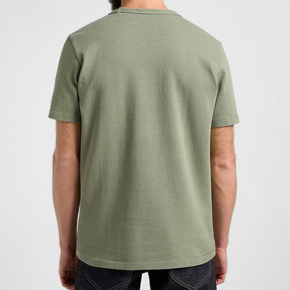 Person wearing a green t-shirt on a plain background