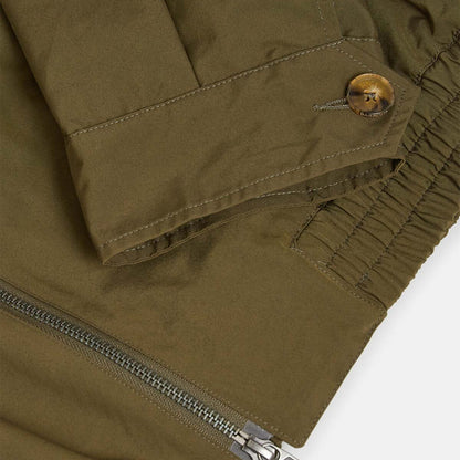 Close-up of a green jacket with a zipper on a white background