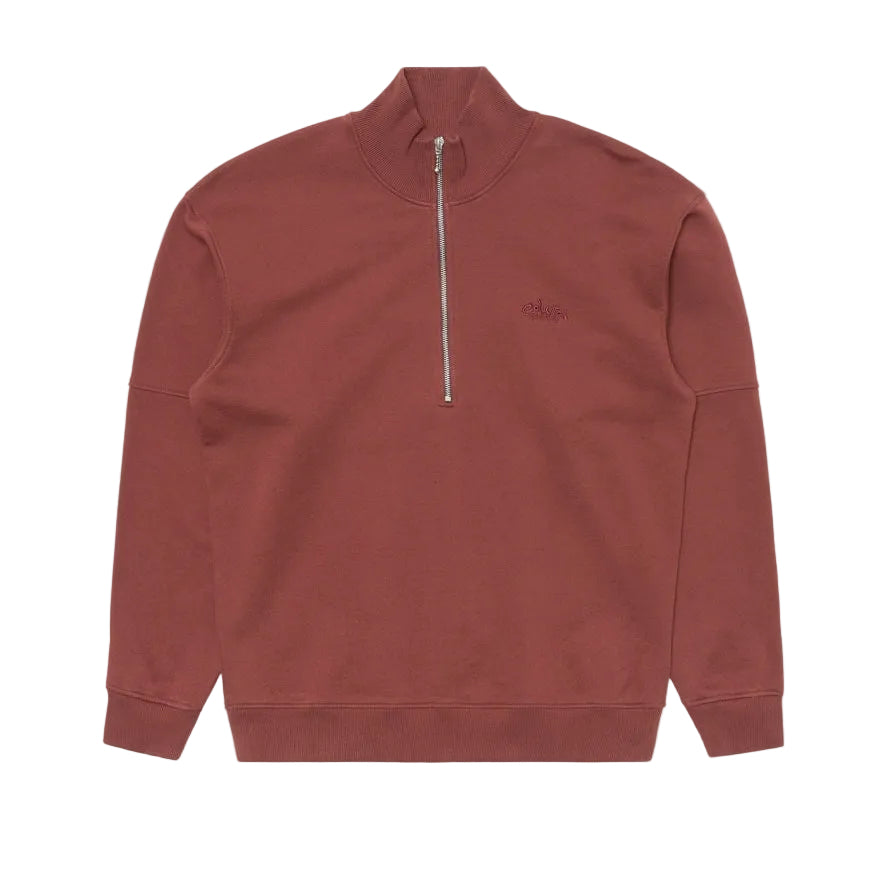 An Edwin Rum-colored quarter-zip sweatshirt with a mock neck collar and a small tonal embroidered logo on the left chest, displayed flat against a light gray background.