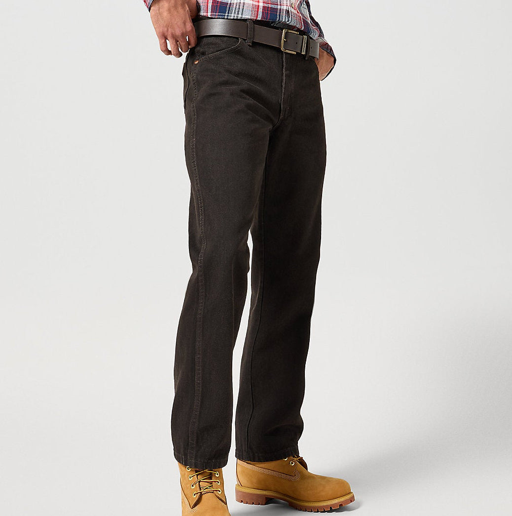 Person wearing a plaid shirt, black pants, and tan boots on a white background