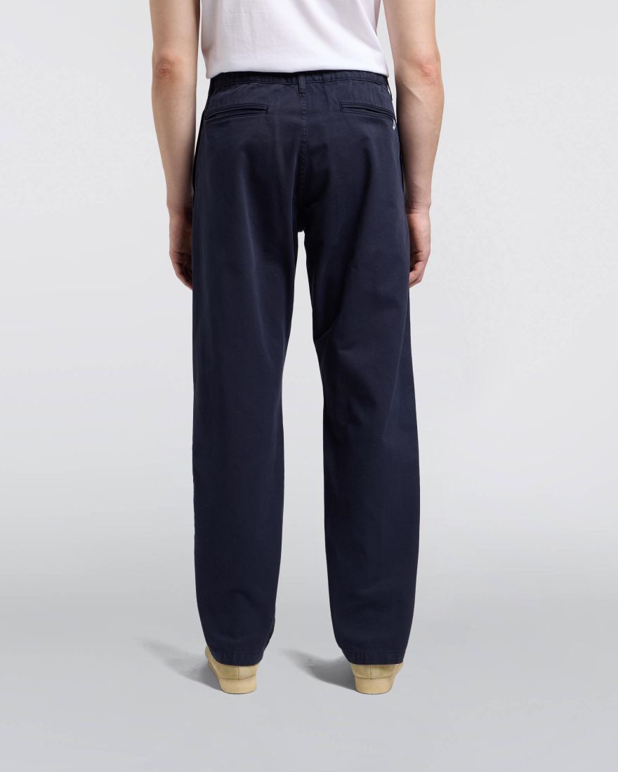 Navy pants worn by a person on a light gray background
