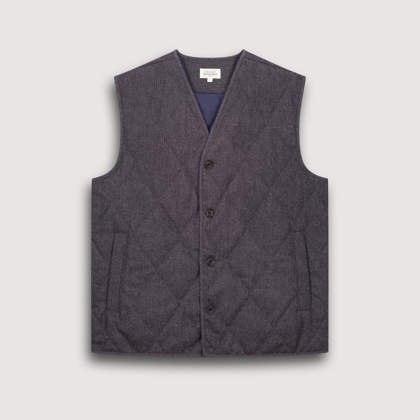 Gray quilted vest on a light gray background