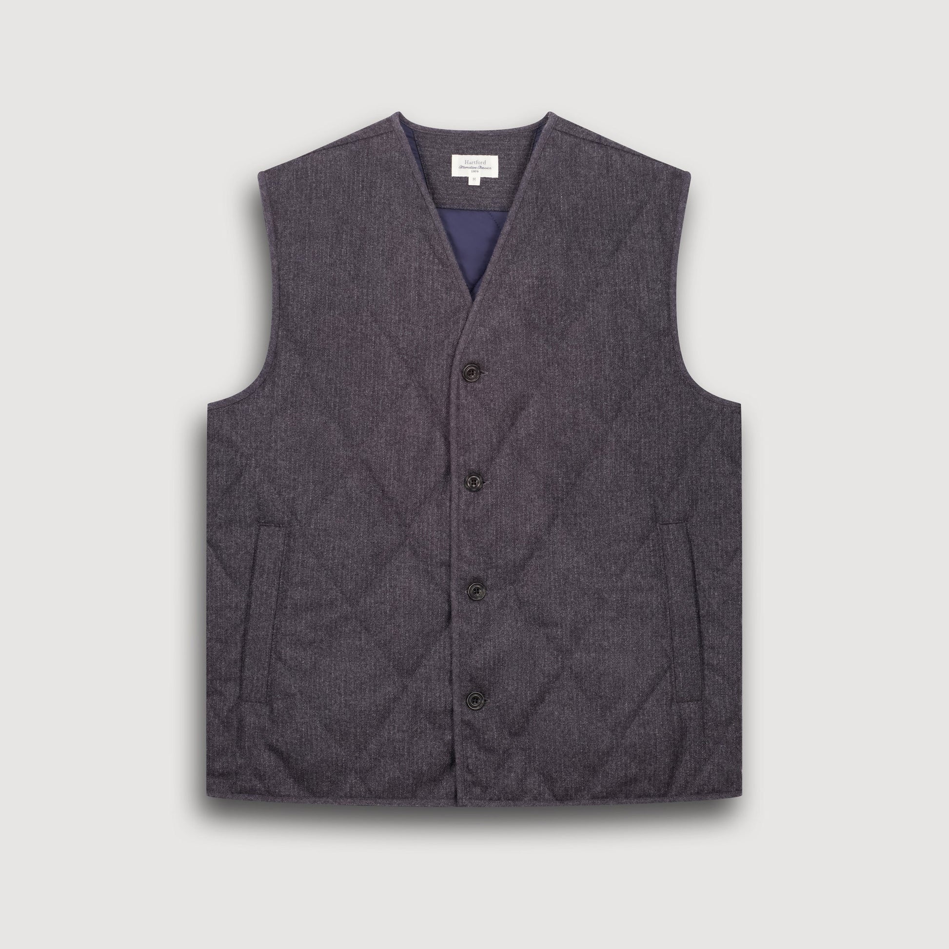 Gray quilted vest on a light gray background