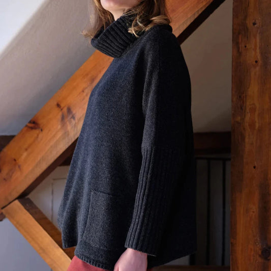 Charcoal high neck oversized jumper with ribbed arms and patch pockets.