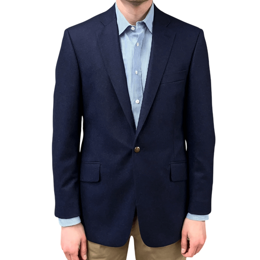 Regent Tailoring blue wool flannel blazer with brass buttons, worn over a light blue striped shirt and tan trousers.