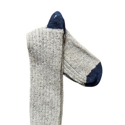 Regent Tailoring grey merino wool blend boot socks with navy blue toe and heel detail on a rustic wooden floor.