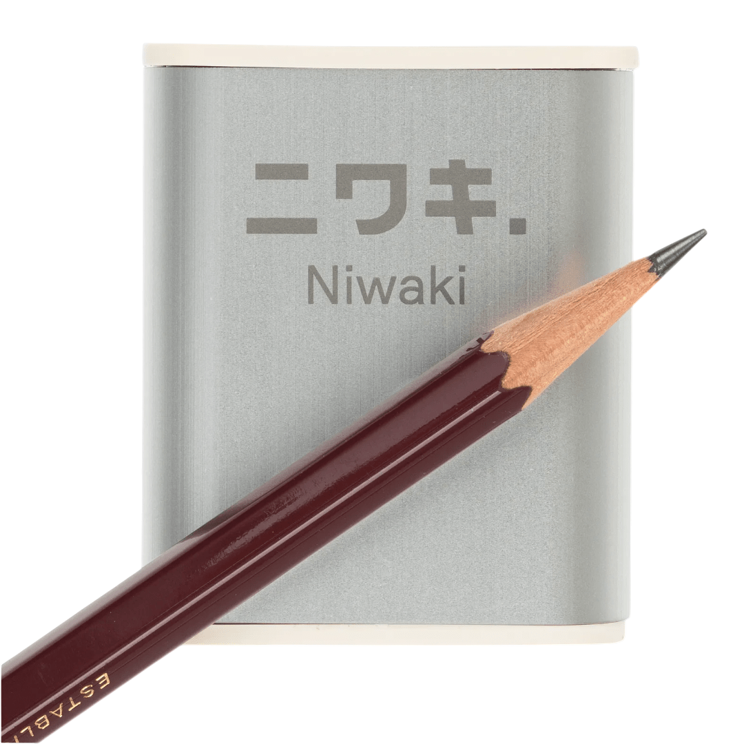 Regent Tailoring Niwaki aluminium pencil sharpener with rice resin base and a dark wood pencil on a white background