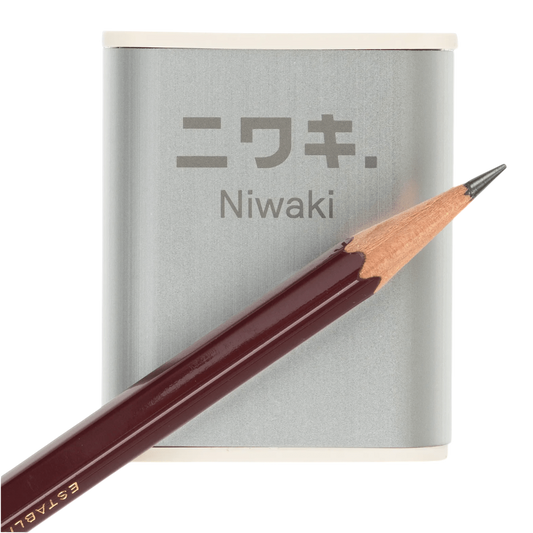 Regent Tailoring Niwaki aluminium pencil sharpener with rice resin base and a dark wood pencil on a white background