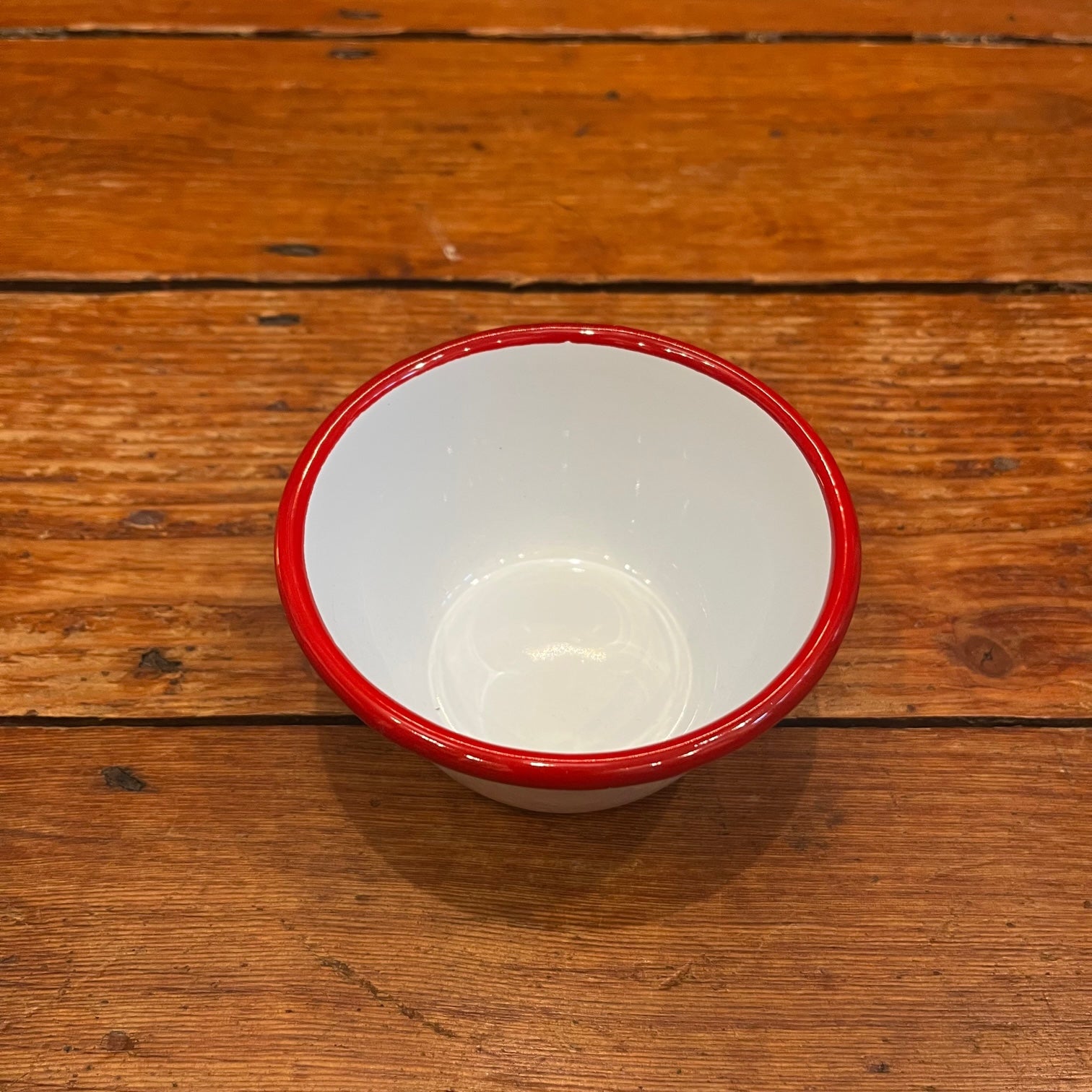 White enamel bowl with red rim 