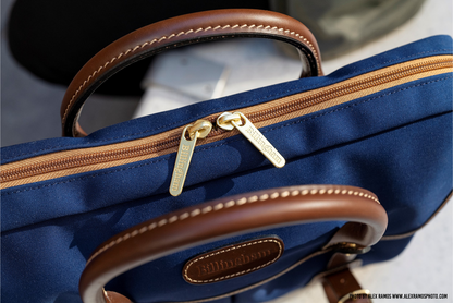 Briefcase with Laptop-Friendly design in navy from Great British travelware experts Billingham, featuring multiple interior organising pockets and 5-year guarantee. 