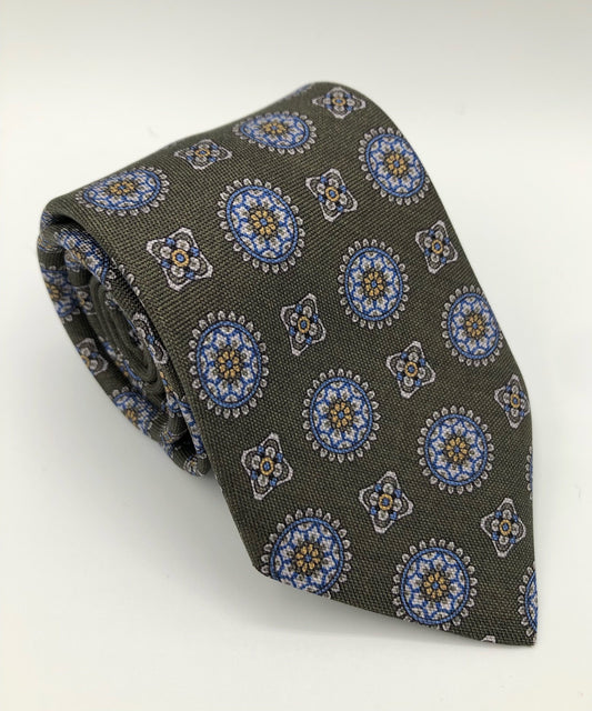 A luxury wool and silk tie designed by and handmade exclusively for Regent. A smart, Italianate olive is picked out by church-like stain-glass geometric shapes. 
