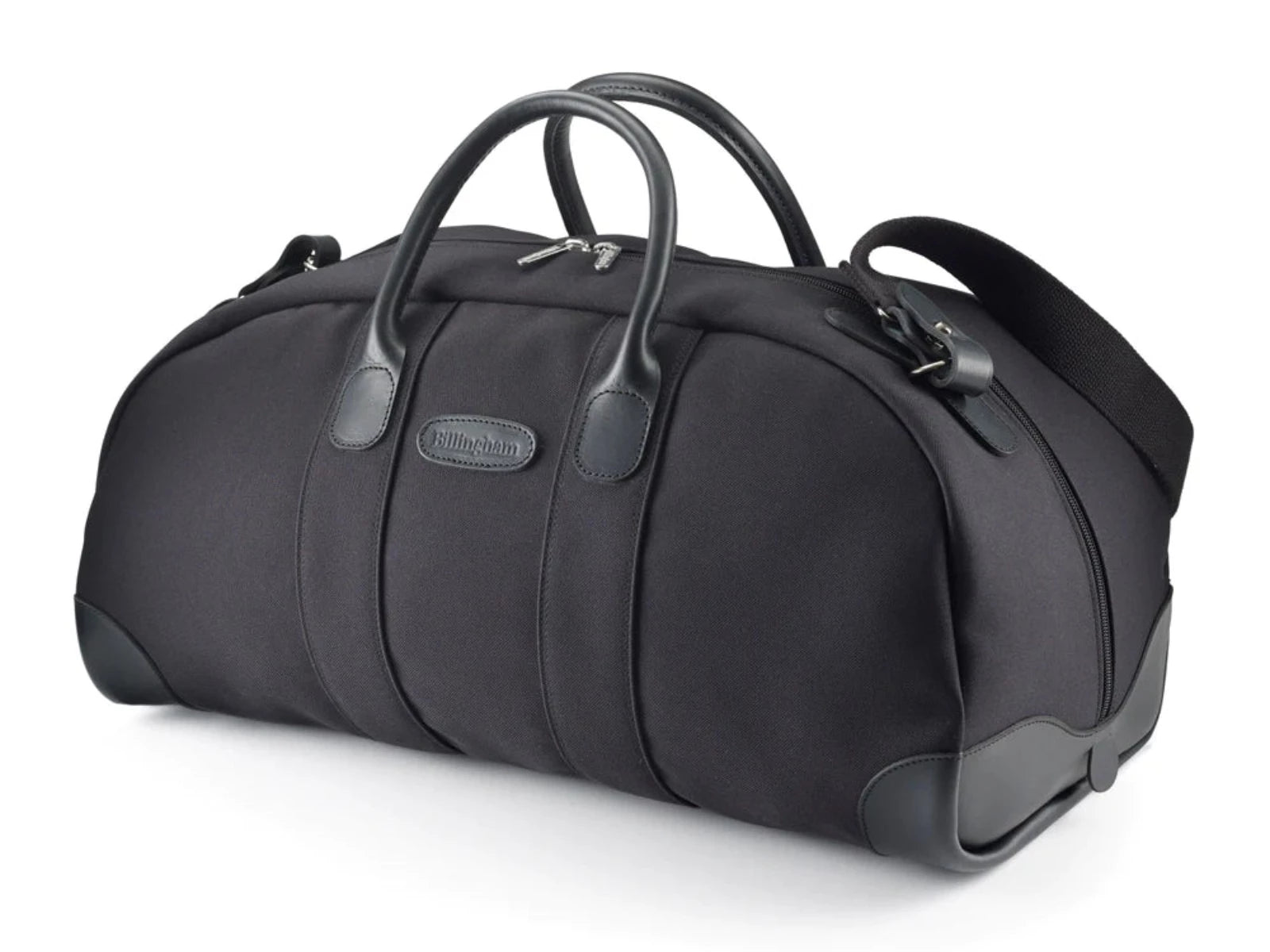 Travel bag weekender size in Black from Great British travelware experts Billingham, featuring waterproof composition, real grain leather, brass fittings and 5-year guarantee. This bag is designed for supreme comfort as well as elegance of design